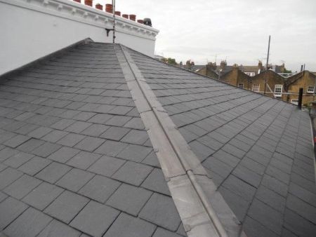 Renewed pitched slate roof with lead hips